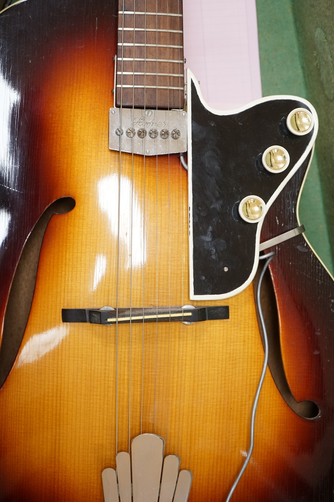 A 1950's Hofner style cut-away acoustic guitar, fitted with a pick up bearing Hofner engraved signature, with hard case.